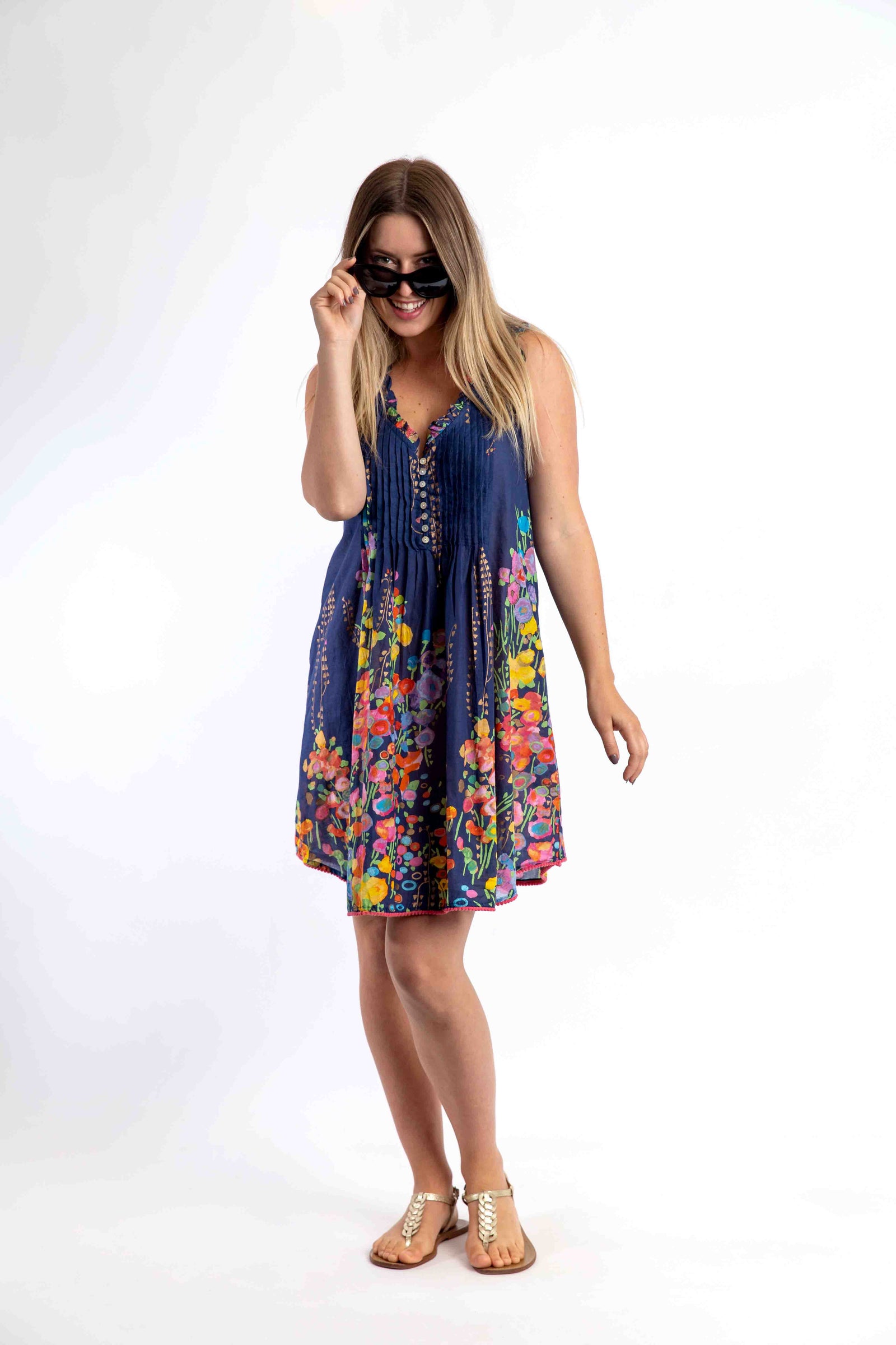 Woman wearing a colorful floral dress on a white background