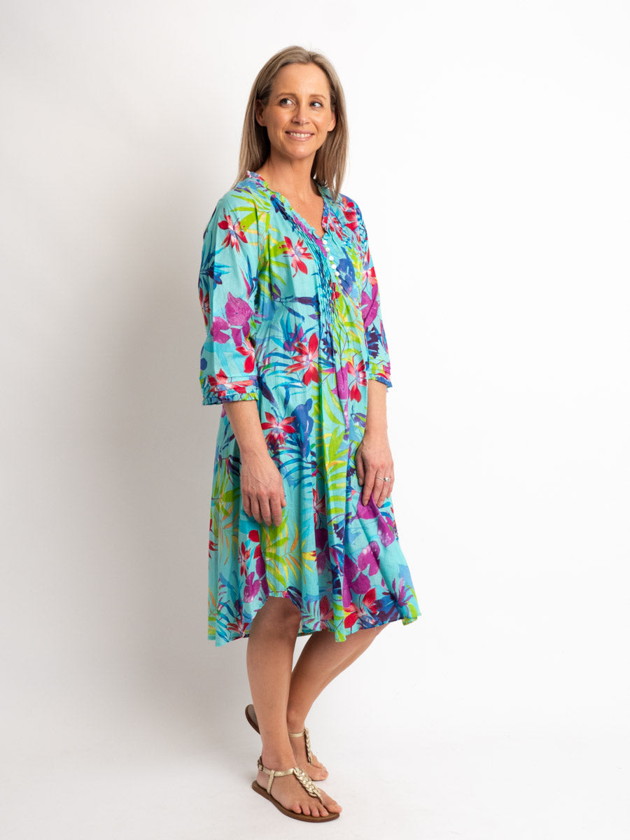 Knee-Length Pleated Dress with Subtle Frills and 3/4 Raglan Sleeve in Turquoise Tropical
