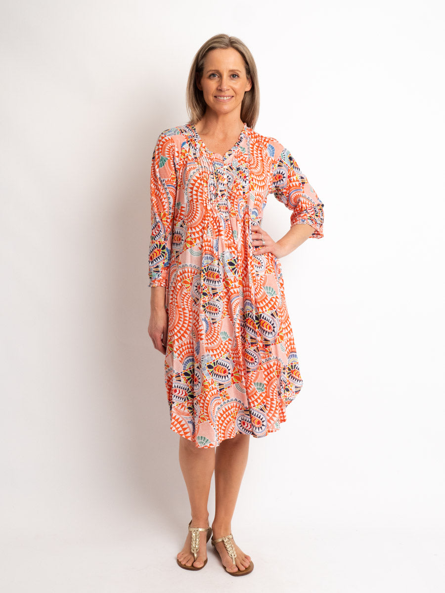 Knee-length Pleated Dress with Subtle Frills and 3/4 Raglan Sleeve in Orange Geo