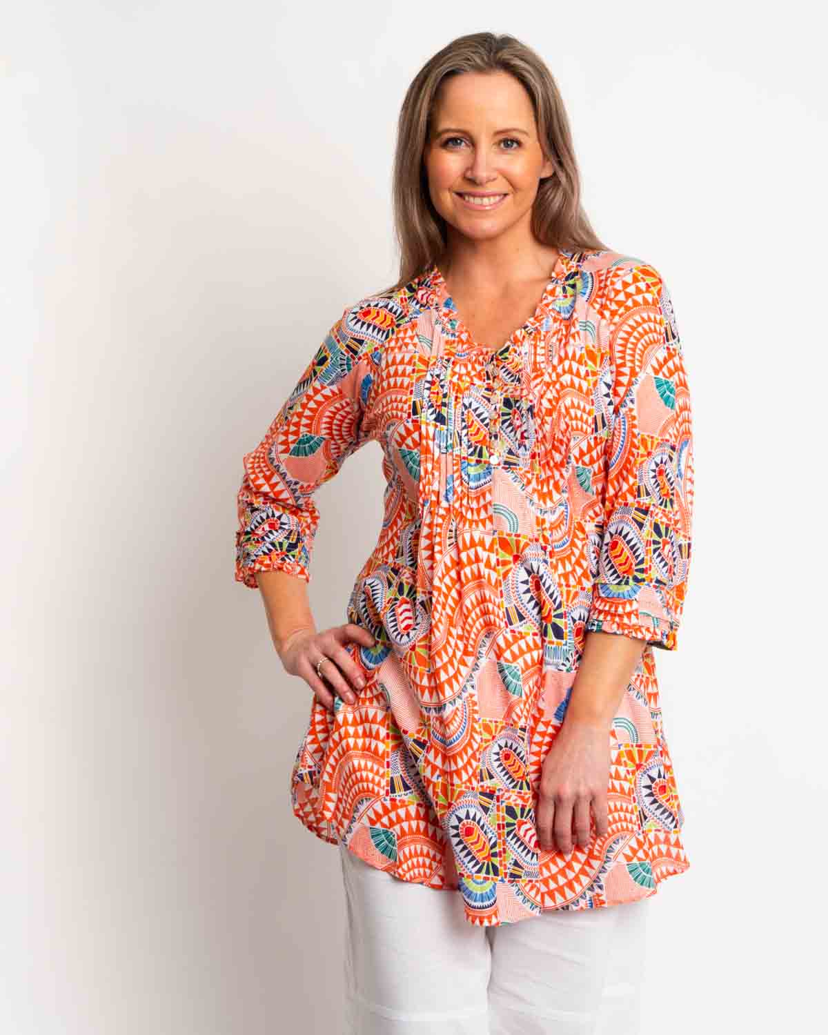 Long Pleated Top with Subtle Frills and 3/4 Raglan Sleeve in Orange Geo